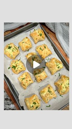 a pan filled with different types of pastries on top of a wooden table next to a