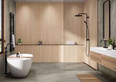 a modern bathroom with wood paneling and large tub in the center, along with two sinks