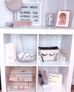 a white shelf filled with cosmetics and other items