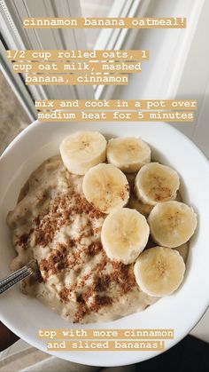 a bowl of oatmeal with bananas and cinnamon on top, in front of a window