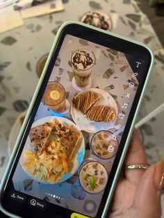 a person holding up a cell phone to take a picture of food on the screen