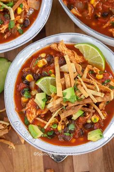 three bowls of mexican chicken soup with tortilla strips and avocado