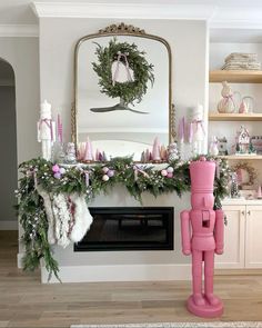 a fireplace decorated for christmas with pink decorations