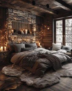 a large bed in a room with candles on the wall and lights hanging from the ceiling