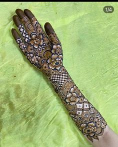 a woman's hand is decorated with hennap and flowers on the palm