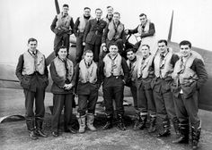 a group of men standing next to each other in front of an airplane