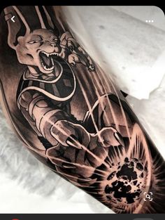 a man's arm with a black and grey tattoo on it, depicting a demon