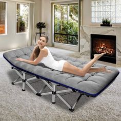 a woman laying on top of a bed in a living room