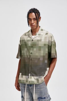 The Pixelated Camo Cuban Half Shirt masterfully combines military elements with a relaxed vibe. This half-sleeve shirt features a unique pixelated camouflage print that incorporates the brand's initial "B" into the design. The classic Cuban collar and side slits at the hem add a touch of sophistication and ease of movement. Made from premium 180g/m² fabric, this slightly oversized shirt offers both comfort and style, making it a perfect choice for casual outings. Pixelated camouflage print with Casual Camouflage Shirt With Graphic Print, Casual Camouflage Shirt For Summer, Casual Camouflage Short Sleeve Shirt, Initial B, Half Shirt, Half Shirts, Half Sleeve Shirts, Camouflage Print, Brand Sale