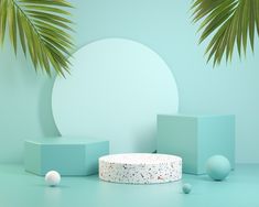 a cake sitting on top of a table next to two balls and a palm tree