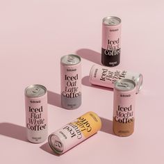 four cans of iced coffee on a pink background