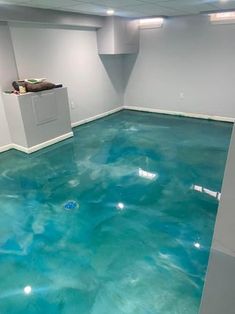 an empty room with blue paint on the floor