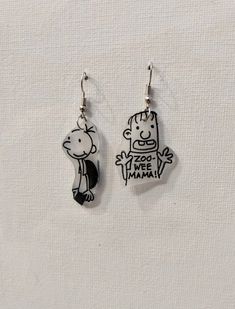 Wear the iconic pair from Diary of a Wimpy Kid, Greg Heffley and Rowley Jefferson! MIddle school has never been so fun! Each pair is hand made so slight variations may occur. Check out my other school theme earrings! https://www.etsy.com/listing/1507902888/back-to-school-teacher-mix-and-match?click_key=d5151c9ad22a5279bfc7ddfad8410710cc8d3f4d%3A1507902888&click_sum=0c8f7c68&ref=shop_home_active_10 Frankenstein Earrings, Kid Earrings, Rowley Jefferson, Star Wars Earrings, Greg Heffley, Eyeball Earrings, Peace Love Dogs, Navy Blue Earrings, Diary Of A Wimpy