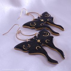 Subtle holographic shimmer accentuates the black polymer clay; gold moons are encased in resin to give strength, shine, and a professional finishing touch. These earrings are sure to make a statement and leave an impression! They measure just under 3 inches long and about 2 inches wide, hang from stainless steel crescent moons and French ear hooks. They are a medium weight, so I do not recommend them for novice earring wearers. The earrings are tough, but I do not recommend wearing in the shower Infinite Jewelry, Manifesting Board, Moth Earrings, Black Polymer Clay, Diy Earrings Polymer Clay, Large Statement Earrings, Luna Moth, Gold Moon, Funky Jewelry