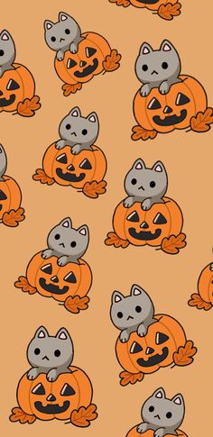 a group of cats sitting on top of each other with pumpkins in front of them