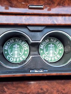 two coffee cups in the center of a car