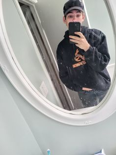 a man taking a selfie in front of a mirror