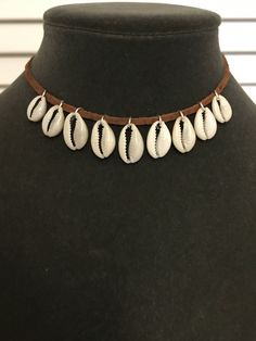 "Hawaii Cowrie shell leather choker necklace. Finished with a silver plated lobster clasp. Choker measures 14\". This is a great necklace to finish the Moana costume. A different length may be sketched upon check out. Warning: Choking hazzard. Not suitable for children 4 years and under. Due to the unique nature of natural shells, each order may vary slightly in appearance. Made in Hawaii." Seashell Necklace Diy, Moana Bebe, Leather Choker Necklace, Seashell Necklace, Leather Chokers, Cowrie Shell, Choker Necklaces, Moana, Diy Necklace