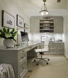 a home office with gray cabinets and white furniture