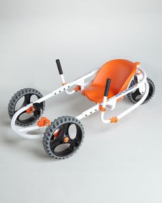 an orange and white toy buggy with wheels