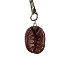 a brown bug charm hanging from a metal chain