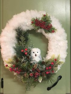 a wreath with a teddy bear on it