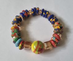 Authentic Ghanaian beaded bracelet From Cape Coast, Ghana. Approximately 10 inches (25.5 cm) circumference Elasticated Colorful Beads Stretch Bracelet, Bohemian Rondelle Bracelets With Polished Beads, Multicolor Bracelets With Large Round Beads, Spiritual Multicolor Stretch Bracelet With Polished Beads, Rondelle Beaded Bracelet With Large Beads As Gift, Multicolor Polished Beads Stretch Bracelet As Gift, Czech Glass Stretch Bracelet With Spacer Beads, Multicolor Stretch Bracelet With Polished Beads As Gift, Multicolor Stretch Bracelet With Polished Beads