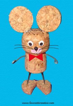 a paper mouse made out of cork with eyes and ears on it's head