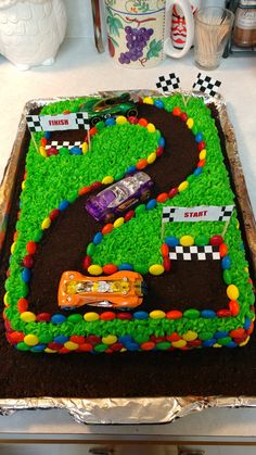 a birthday cake that is shaped like a race track