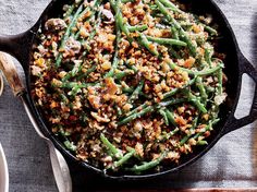 a skillet filled with green beans and stuffing