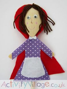 a doll made out of felt with a red cape