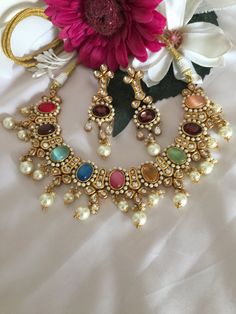 Adorn yourself with this gorgeous Jadau kundan Jewellery piece. You will definitely fall in love with the multicoloured Hydro Quartz stones. The statement Kundan earrings add to the charm of the beautiful royal necklace. Handcrafted by our skilled Indian craftsmen in brass with gold plating. The stunning premium quality collar necklace comes with a beautiful dori and is adjustable. Length of earrings: 8 cms, push back closure and a support clip at the back. One of our favourite picks for the wedding season ❤️ The necklace and earrings are the same as shown in the pictures. We have only one piece in this color and design, hence you get what you see in the pictures. Multicolor Jeweled Kundan Necklace In Fusion Style, Multicolor Jeweled Kundan Fusion Necklace, Fusion Multicolor Meenakari Bridal Necklace, Multicolor Meenakari Fusion Bridal Necklace, Traditional Multicolor Multi-stone Jewelry Set, Fusion Style Multicolor Meenakari Bridal Necklace, Multicolor Fusion Kundan Necklace With Meenakari, Multicolor Multi-stone Kundan Necklace For Gift, Fusion Style Multicolor Kundan Necklace With Meenakari