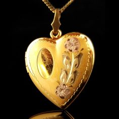 This is a sweet yellow gold filled heart shaped locket. The front has a beautiful etched floral design. The back is plain. It opens up to reveal a compartment perfect for two small photos. A great way to keep those you love close to your heart. The chain measures 17 1/2 inches long The pendant measures 1 3/8 inch (35.25mm) tall including bail 7/8 inch (23.57mm) wide The locket is marked 1/20 12k GF The necklace weighs 6.7 grams It is in ready to wear vintage condition. It does show some wear and Heart Shaped Locket, Floral Heart, Small Photos, Dream Jewelry, Locket Necklace, Vintage Floral, Locket, Favorite Jewelry, Gold Filled