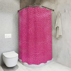 a white toilet sitting next to a pink shower curtain