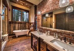 a bathroom with two sinks and a bathtub next to a large window in the wall