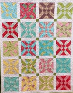 a quilt made with different colors and patterns on the front, side, and back