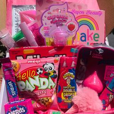 a pink box filled with lots of candy