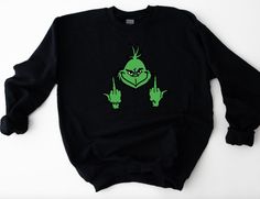 Funny Grinch Face Sweatshirt and Shirt options available. Please read drop down menu carefully as I have sweatshirt and shirts options available. If you have any questions please feel free to reach out. Thank you. Grinch Sweater Ideas, Black Christmas Sweatshirt For Streetwear, Christmas Long Sleeve Sweatshirt For Streetwear, Winter Fan Apparel Tops, Green Crew Neck Novelty Top, Novelty Long Sleeve Sweatshirt, Novelty Long Sleeve Cotton Tops, Novelty Cotton Long Sleeve Tops, Cotton Novelty Long Sleeve Tops