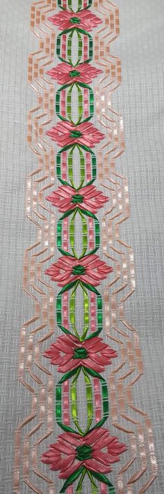 an image of some very pretty designs on the table cloth with ribbons in it's center