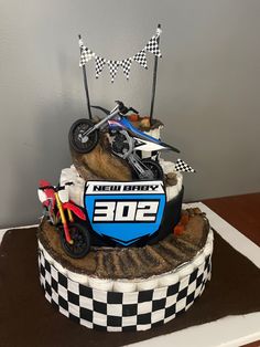 motocross track, diaper cake, baby shower, dirt bikes, new baby Dirtbike Gender Reveals, Gender Reveal Dirtbike, Dirt Bike Cake, Dirt Bike Birthday Cakes For Boys, Dirt Bike Baby Shower Ideas, 2nd Birthday Dirt Bike Theme, Dirt Bike Baby Announcement