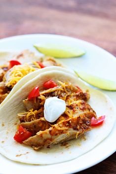 two tacos are sitting on a white plate