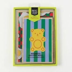 a wooden toy with a bear on it's back in a green and blue box