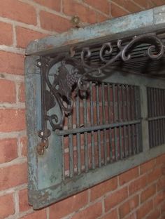 an old iron window on the side of a brick building