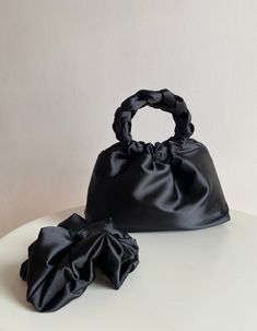 Beautiful small handbag in black color. Elegant and stylish woman bag. Bag with round handles is perfect for weddings, parties and will fit perfectly into any image. It holds a phone, a cosmetic bag, a wallet, keys and other small things. Size 25*18*8cm Material: Soft, pleasant to the touch, matte fabric with a delicate sheen gives the fabric a class, pouring, non-translucent. Quality: Premium Top Quality Can be washed entirely by hand. Satin handbag consists of 3 layers: the outer material and Chic Pouch Evening Bag, Chic Evening Bag With Round Handle, Evening Bag With Removable Pouch And Round Handle, Elegant Evening Bag With Removable Pouch And Round Handle, Chic Evening Gift Bag, Evening Bag With Round Handle And Dust Bag, Evening Bag With Rolled Round Handles, Elegant Black Bag With Rolled Handles, Elegant Evening Bag As Gift