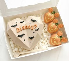 a cake in the shape of a heart with pumpkins and jack - o'- lanterns