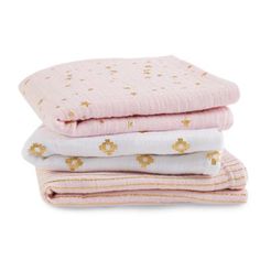 three pink and white blankets stacked on top of each other, with gold stars in the middle