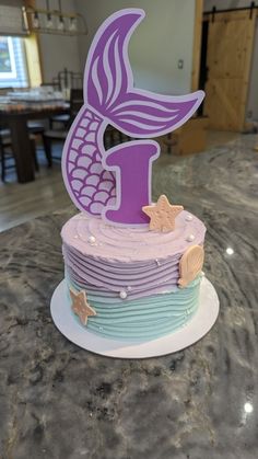 a purple and blue cake sitting on top of a counter