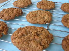 some cookies are cooling on a rack and ready to be baked in the oven for consumption