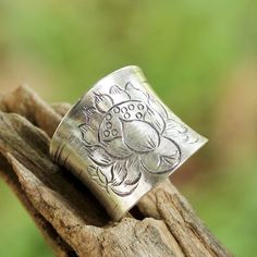 A blooming lotus flower is etched into the band of this wrap ring from Achara. The oxidized finish makes the flower stand out against the sterling silver, along with numerous etched lines of varying lengths that extend from the back and accentuate the curve of the ring. Silver Wrap Ring, Elephant Ring, Sterling Silver Rings Bands, Wrap Ring, Heart Dangle Earrings, Sterling Silver Cuff Bracelet, Unique Jewelry Designs, Bling Rings, Silver Band Ring