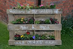 a wooden pallet filled with flowers and plants